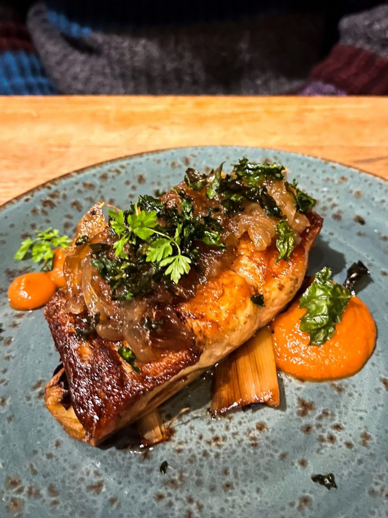 Piece of pan fried pollock topped with caramelised onions.