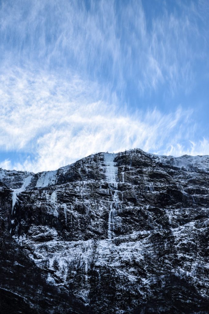 Frozen waterfalls coming down snowy mountains in Norway