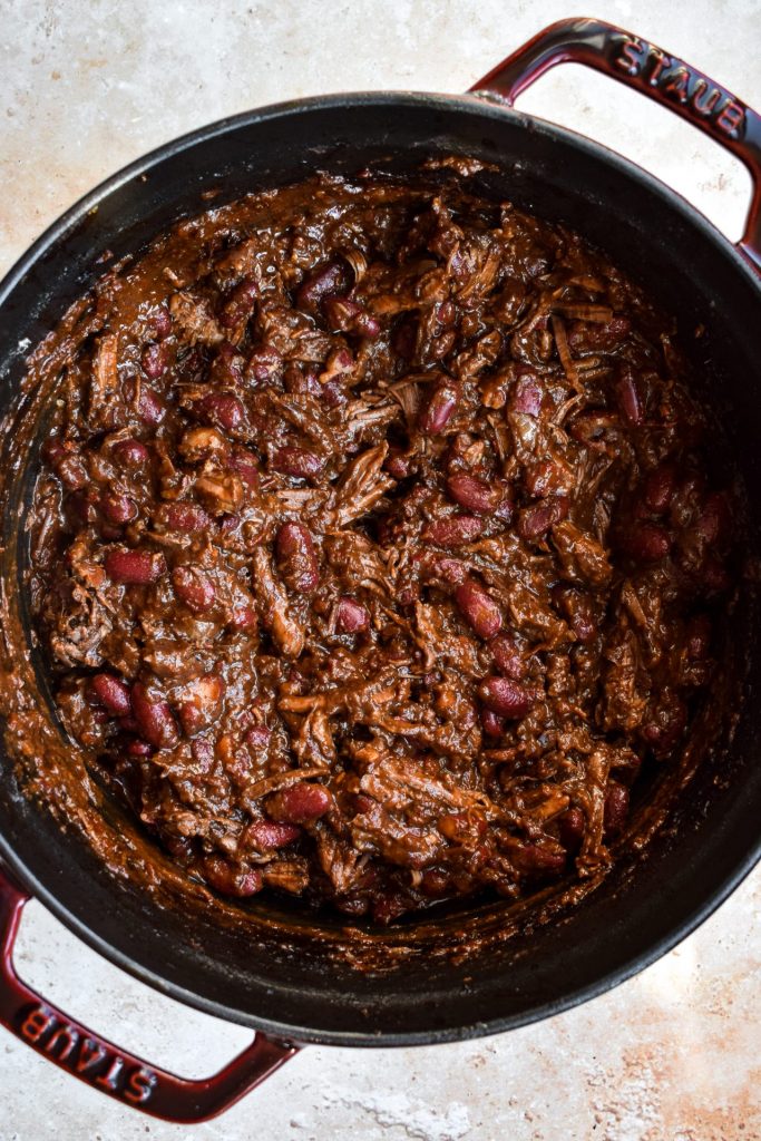 Pot of short rib chili with kidney beans pictured close up.