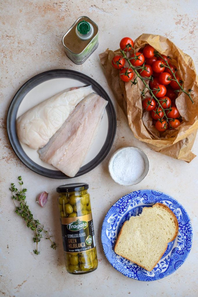 Laid out ingredients to make Baked White Fish with Tomatoes and Olives