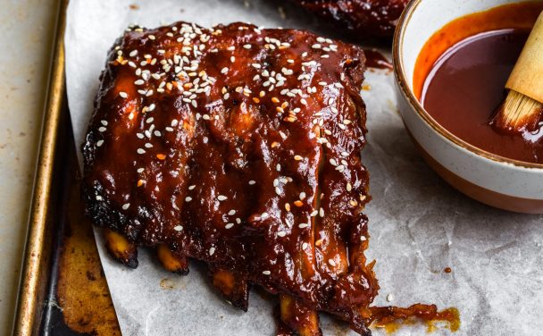 Close up of a half rack of gochujang ribs sprinkled with sesame seeds.
