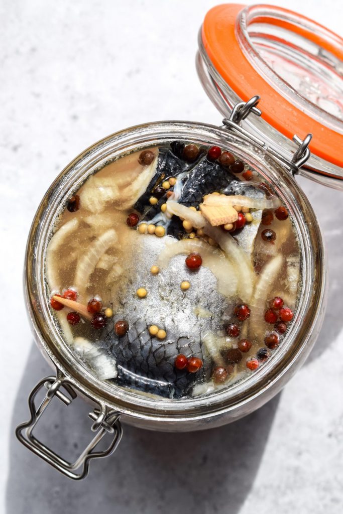 Overhead image of an open clip top jar of herring rollmops.