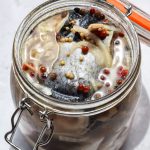 Clop top jar of herring rollmops in their preserving liquid.