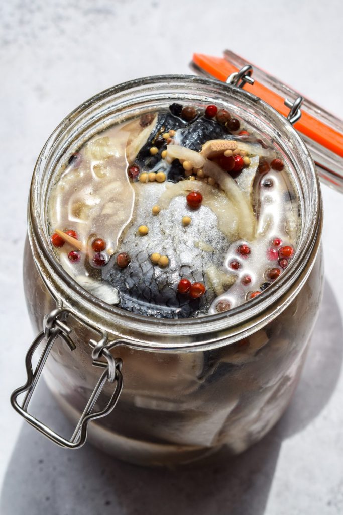 Clop top jar of herring rollmops in their preserving liquid.