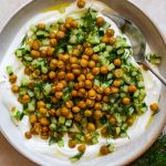 Crispy chickpeas and a dill and cucumber salad piled onto a bowl of thick Greek-style yogurt.